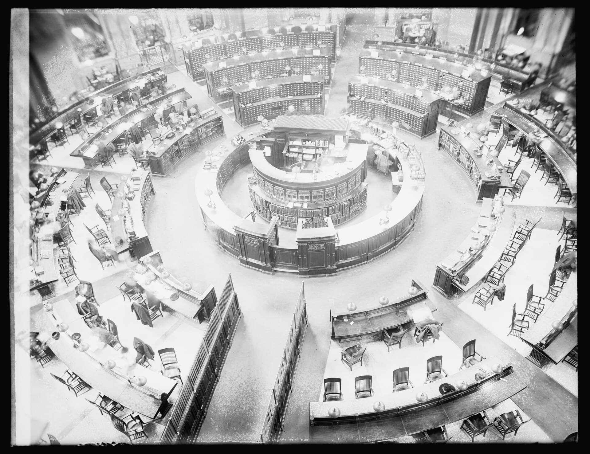 The main reading room of the Library of Congress seen from above, readers at circular desks